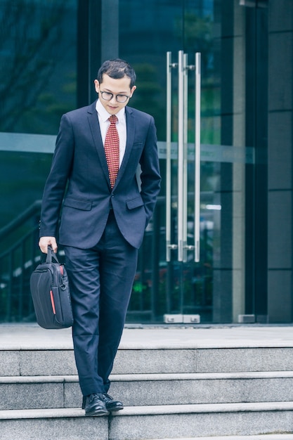 Free photo business men carry laptops to the office building