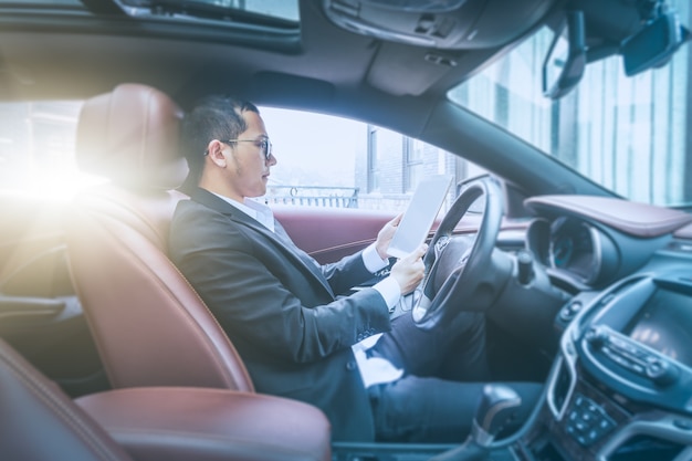 Free Photo business men work with tablet computers in their cars