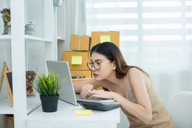 business owner working at home office packaging 