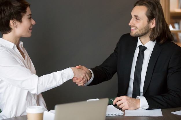 Business partners handshaking after closing successful deal