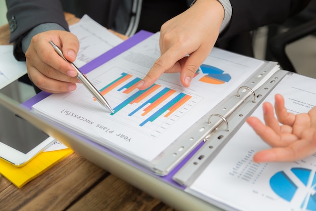 Business people analyzing a bar chart