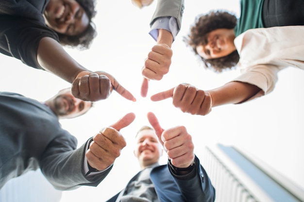 Business people giving a thumbs up