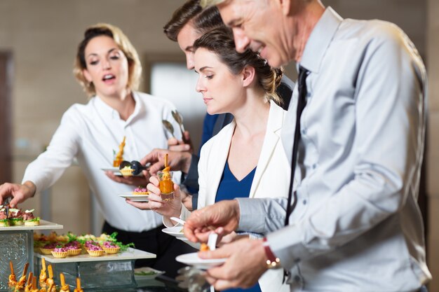 Business People Serving Themselves with Snacks