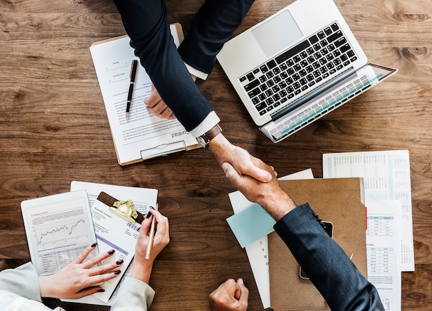 Free photo business people shaking hands together