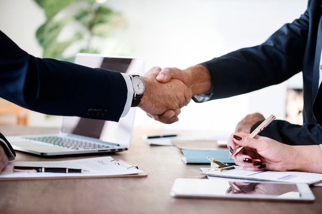 Free photo business people shaking hands together