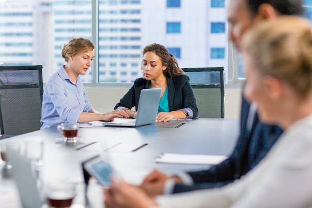 Free photo business people talking at a meeting table