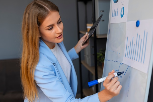 Free photo business person looking at finance graphs