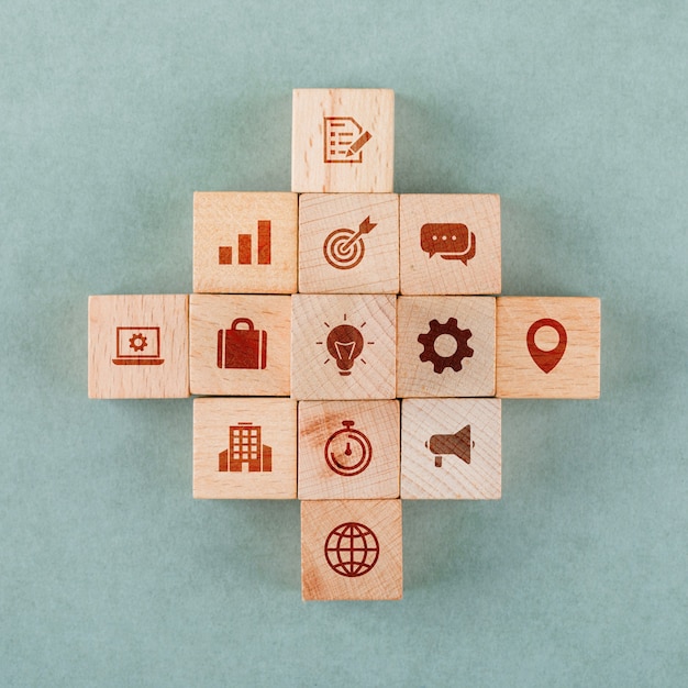 Free Photo business strategy concept with wooden blocks with icons.