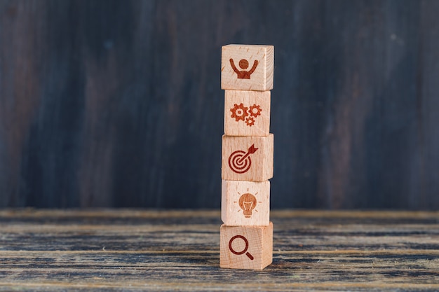 Free photo business strategy concept with wooden cubes on wooden and grunge background side view.