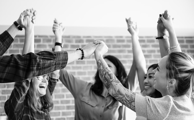 Free Photo business team hands raised with successful