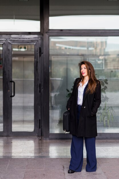 Business woman in black clothes standing outside