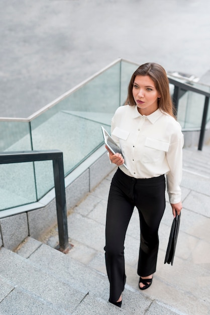 Free Photo business woman climbing up the stairs