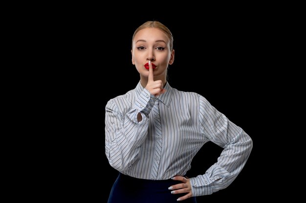 Business woman cute blonde girl showing silence gesture with red lipstick in office outfit