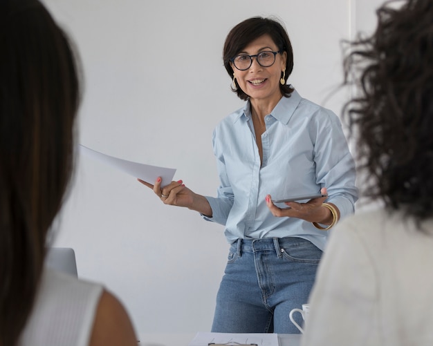 Business woman explaining something to her colleagues