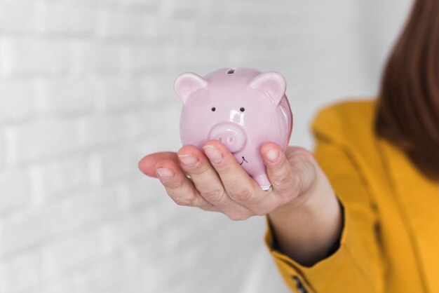 Business woman holding piggy bank