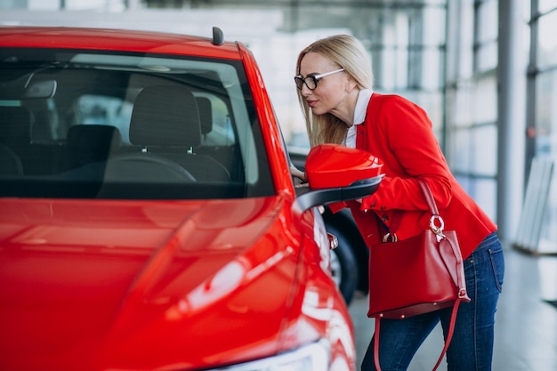 Business woman looking for an auto mobile at a car showroom