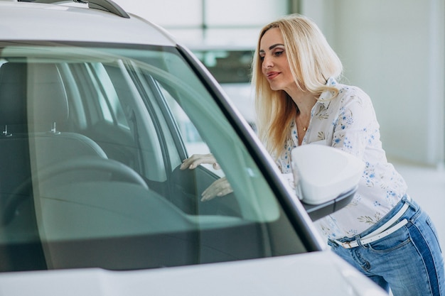 Business woman looking for an auto mobile at a car showroom