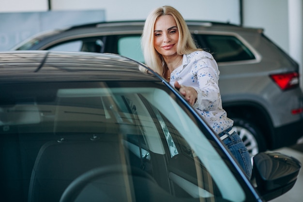 Business woman looking for an auto mobile at a car showroom