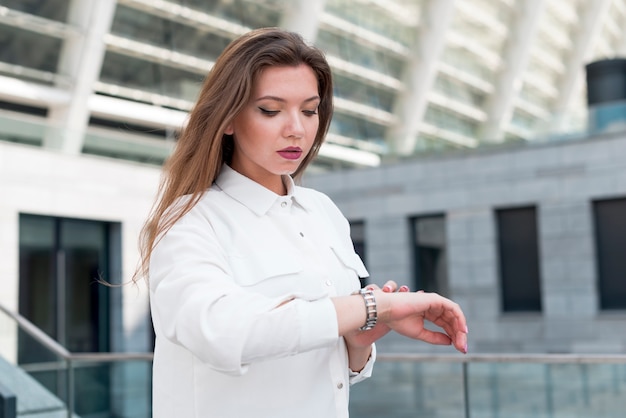 Free Photo business woman looking at her watch