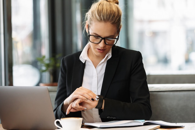 Business woman looking at watch.