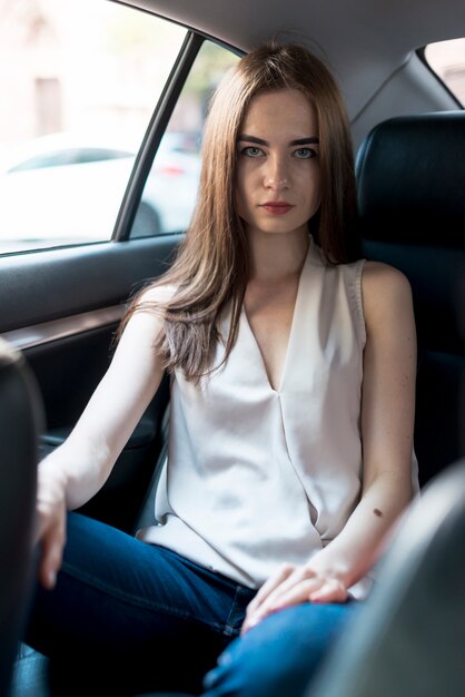 Business woman posing inside a car