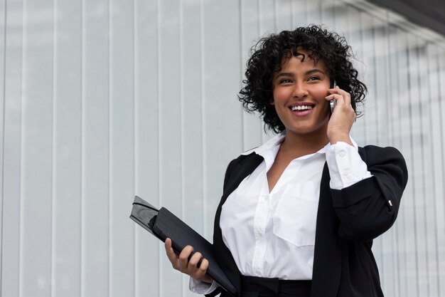 Business woman talking on phone side view