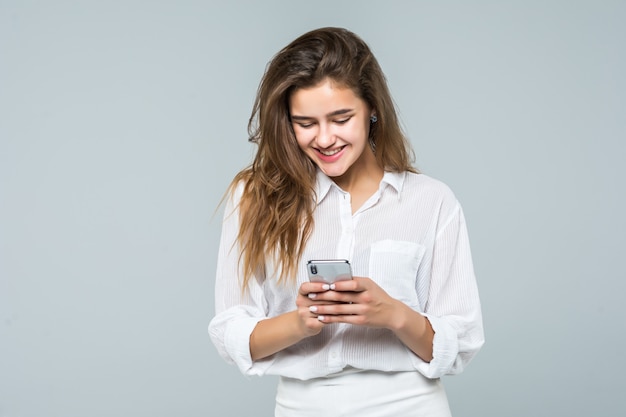 Business woman texting on her mobile phone - isolated over white background