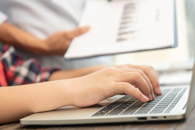 Free photo business woman typing on laptop at workplace woman working in office hand keyboard.