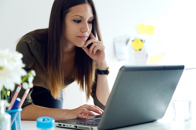 Business woman using her laptop in the office.