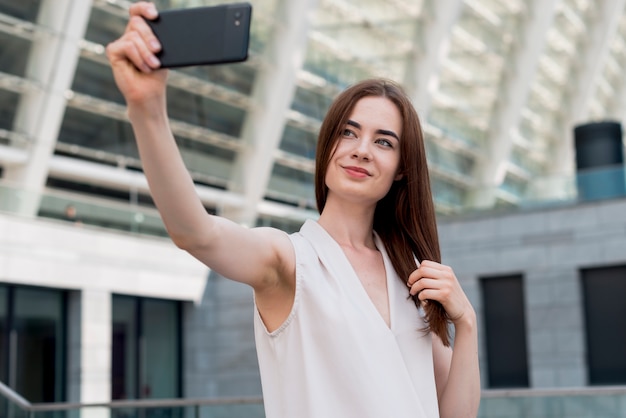 Business woman using smartphone in the street