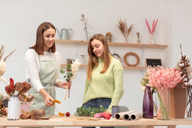 Business women arranging a bouquet of flowers