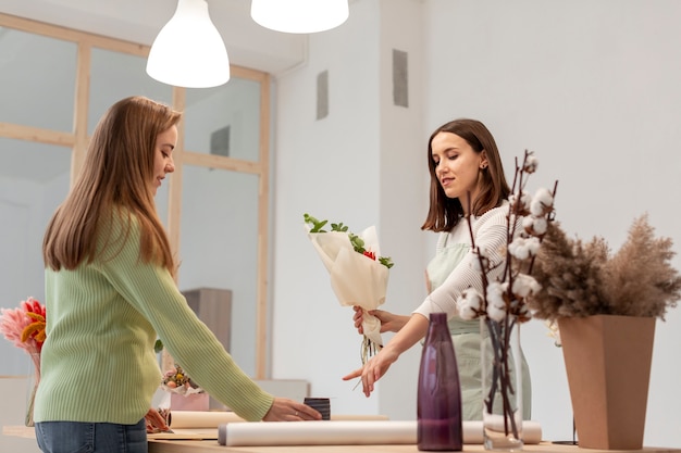 Business women making a bouquet long view