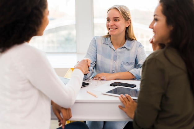 Business womens shaking hands