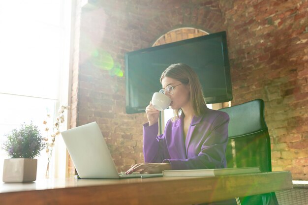 Business young caucasian woman in modern office with team