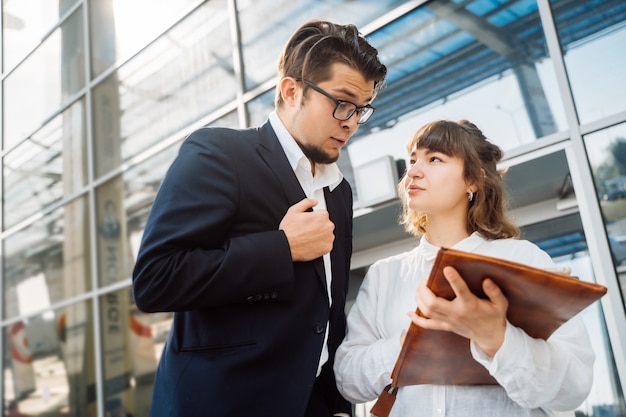 Businessman and businesswoman look at important papers