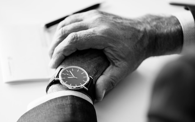 Businessman checking time on hand watch