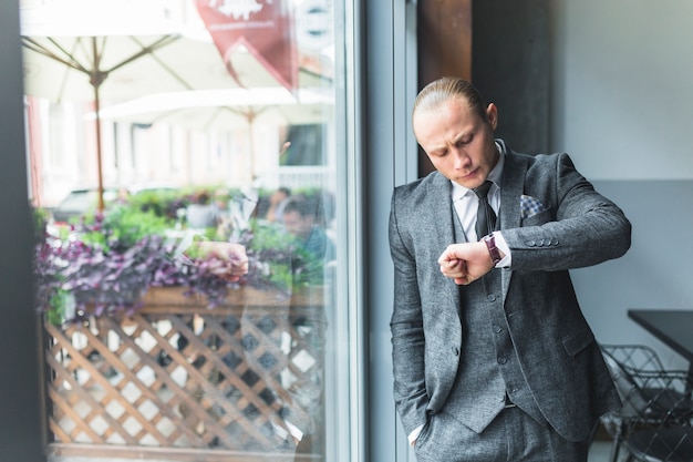 Free photo businessman checking time on his wristwatch