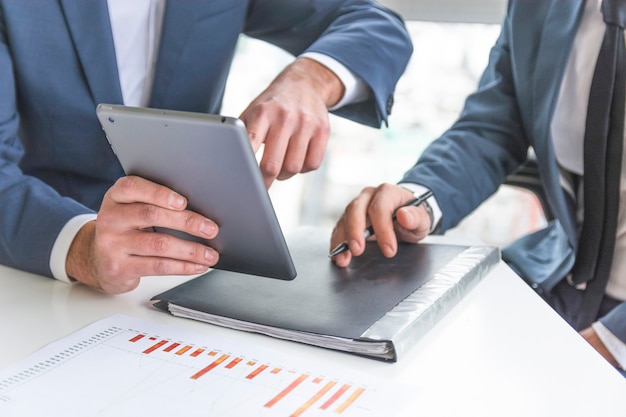 Businessman discussing on digital tablet at workplace