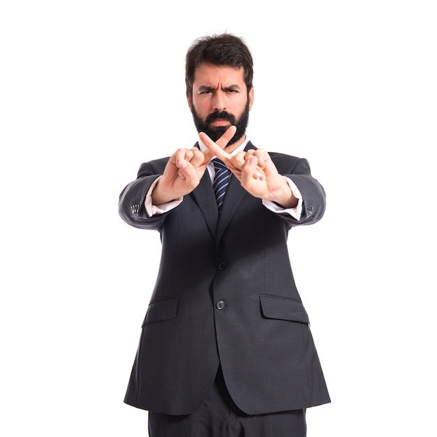 Businessman doing NO gesture over white background