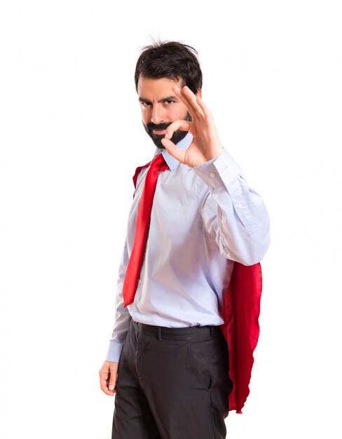 Businessman dressed like superhero making Ok sign