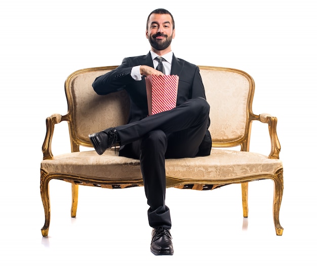 Businessman eating popcorns