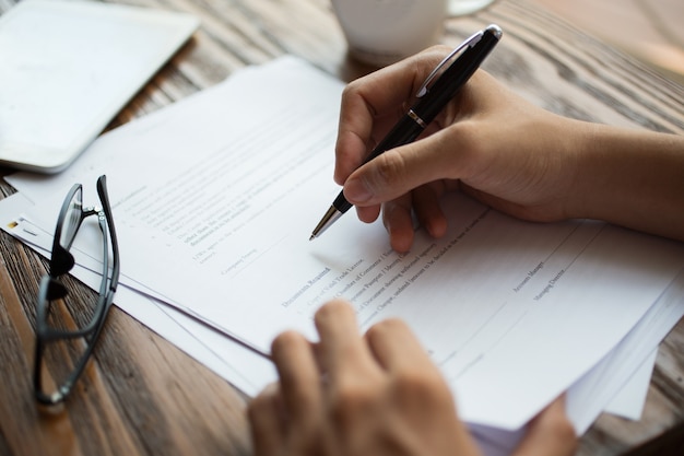 Businessman examining papers at table