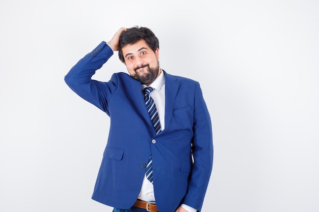 Businessman in formal suit putting hand on head and looking happy , front view.