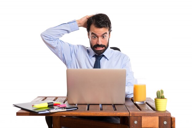 Businessman in his office having doubts