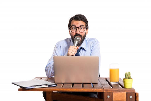 Free Photo businessman in his office singing