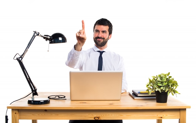 Free photo businessman in his office touching on transparent screen