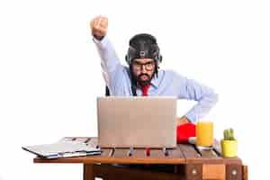 Free photo businessman in his office with pilot hat