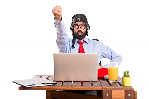 Free photo businessman in his office with pilot hat