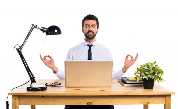 Businessman in his office in zen position