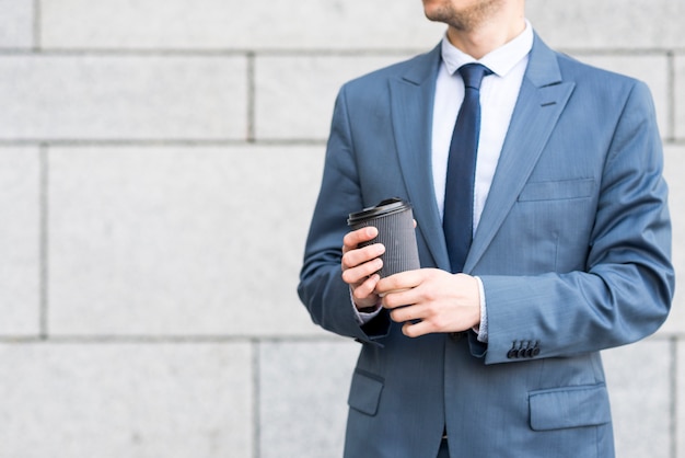 Businessman holding coffee cup